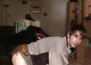 Lovely 18-year-old boy in a cozy sweater bottoms for his animal