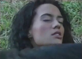 Brunette moans as her pussy gets penetrated by a horse's shaft